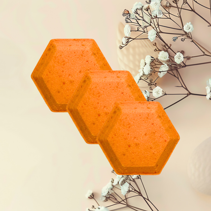 Three orange hexagonal steamer on a light beige background with white flowers and branches.