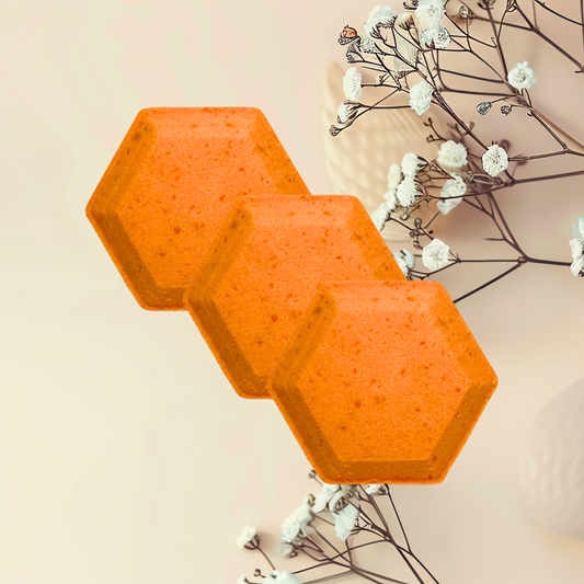 Three orange hexagonal steamer on a light beige background with white flowers and branches.
