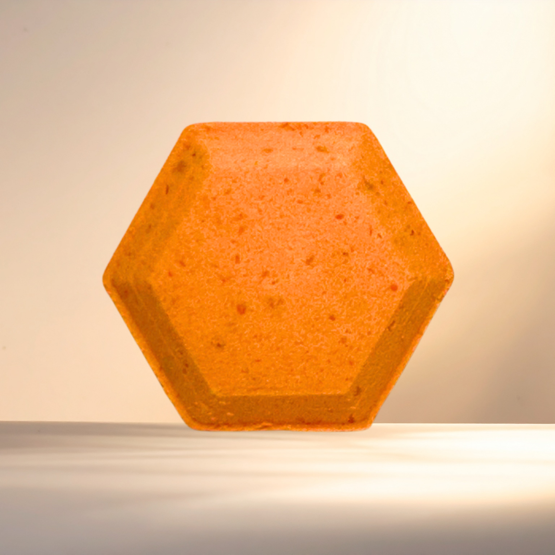 Hexagonal orange steamer on a beige background