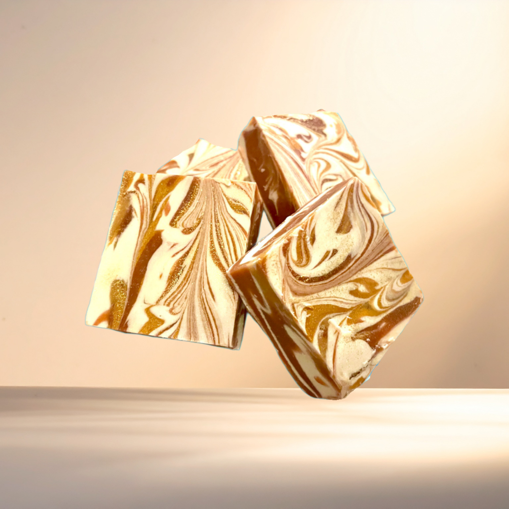 Several gold marbled soaps on a light background