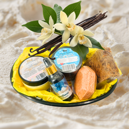 Gourmet gift set with vanilla beans, flowers, and a bottle on a white background