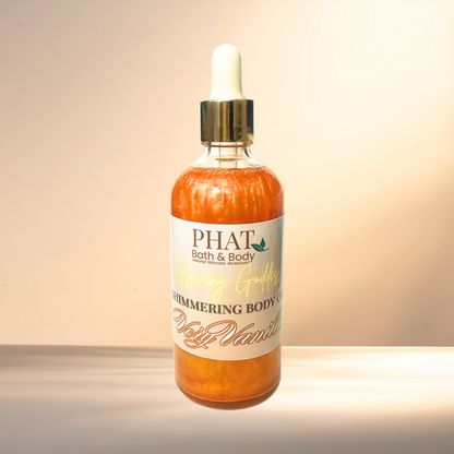 Bottle of 'Very Vanilla' shimmering body oil from PHAT Bath & Body on a gradient background