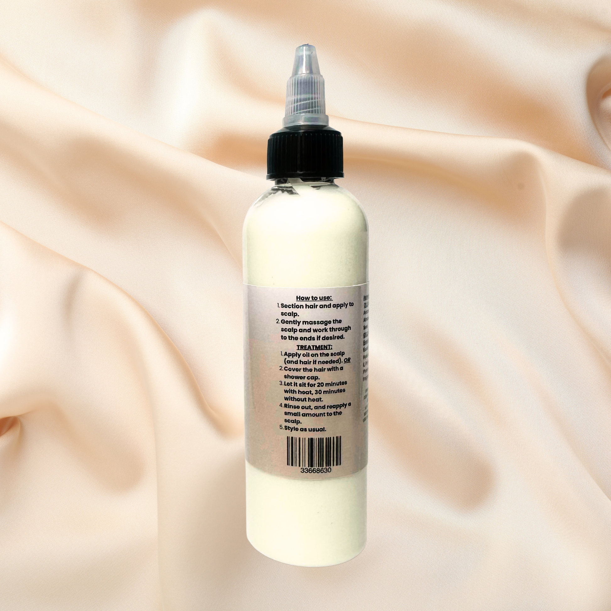 Bottle of hair product with a twist top on a beige fabric background