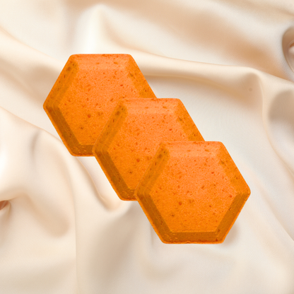 Three orange hexagonal steamer on a beige fabric background
