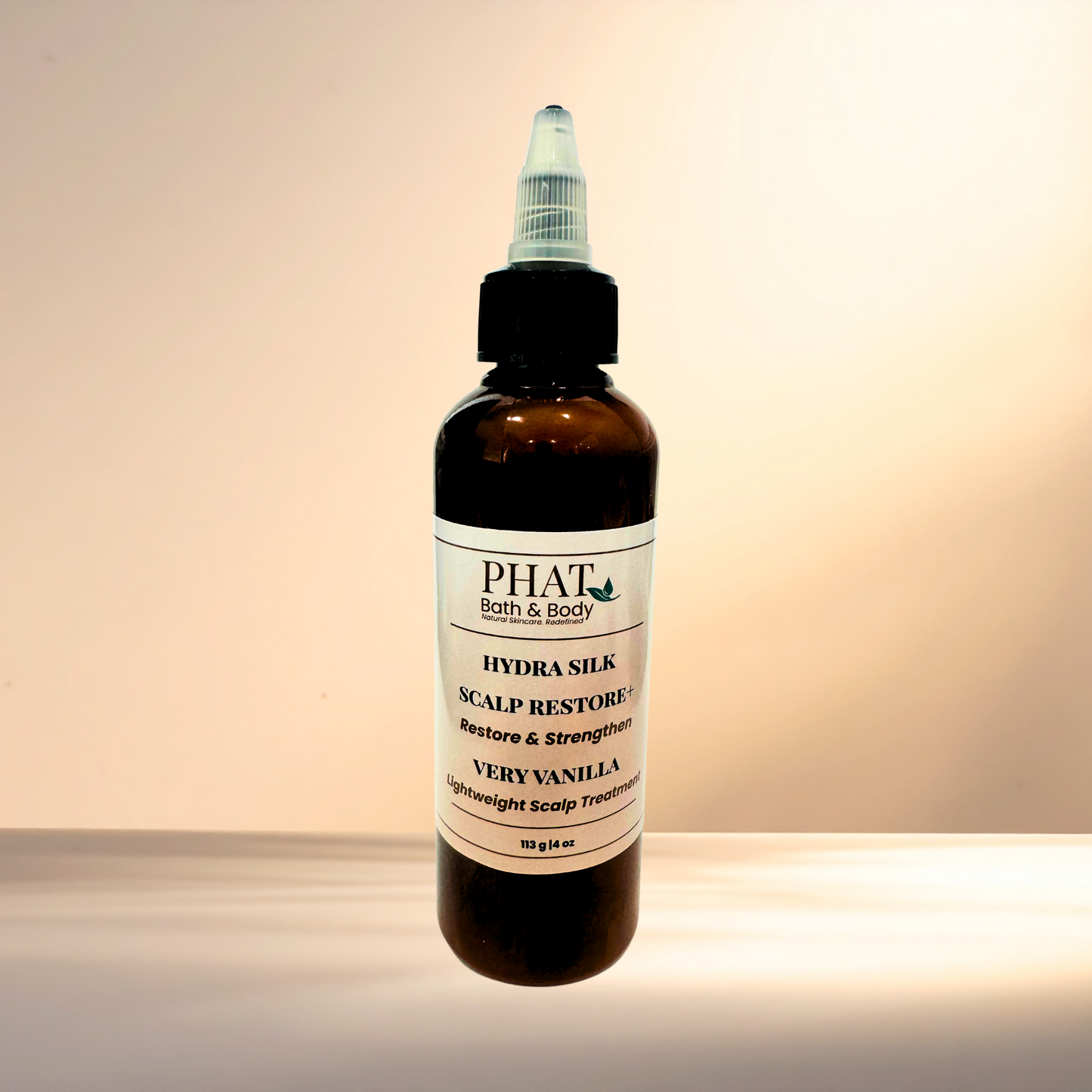 Bottle of PHAT Bath & Body Hydra Silk Scalp Restore treatment on a gradient background