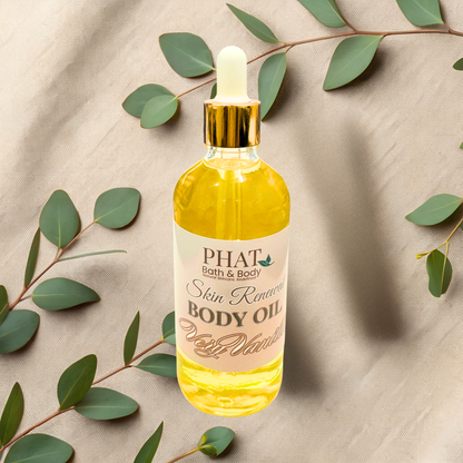Bottle of Phat Bath & Body body oil with a dropper on a beige fabric background with green leaves.