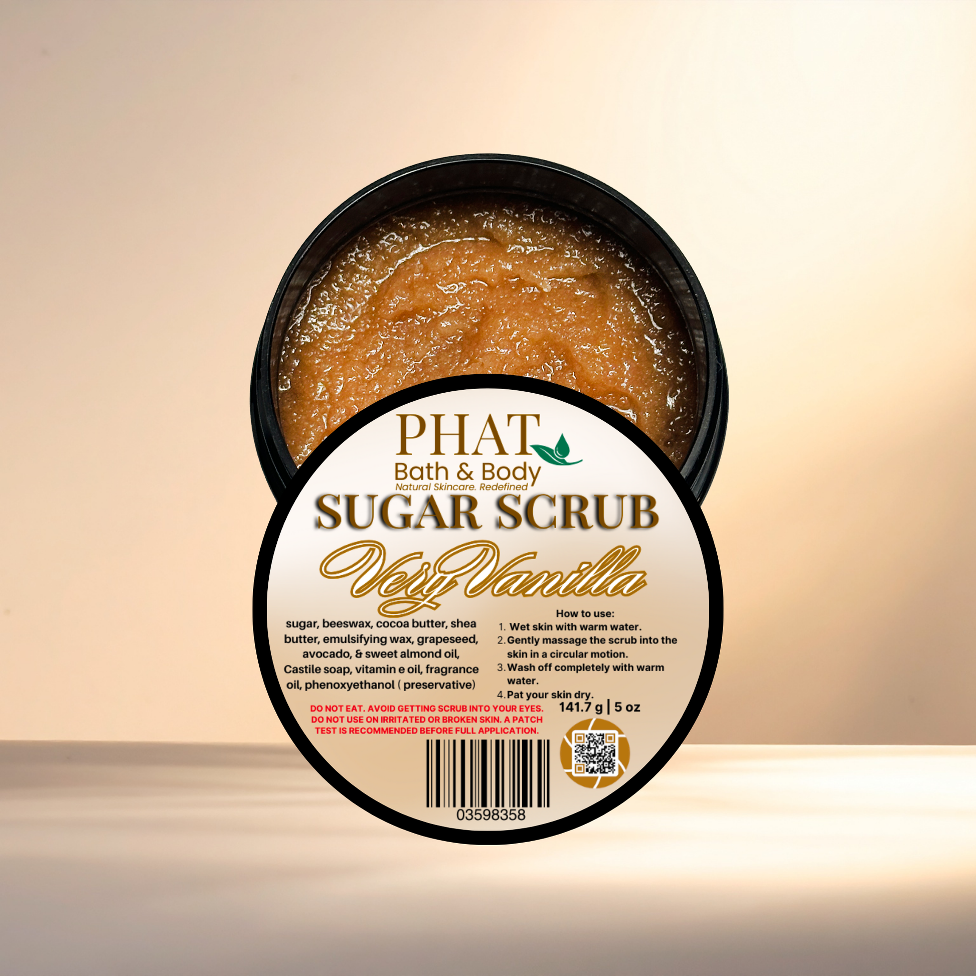 Jar of sugar scrub with 'Phat Bath & Body' label on a beige background