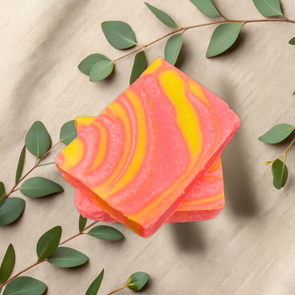 Colorful striped soap bar with green leaves on a beige fabric background