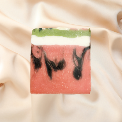 Bar of soap with watermelon pattern on a beige fabric background