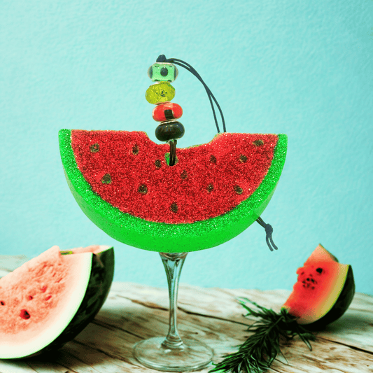 Decorative watermelon slice car freshie on a cocktail glass with a light blue background