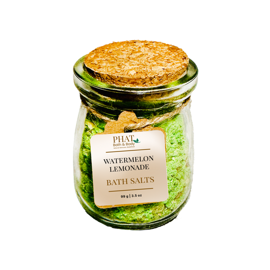 Jar of watermelon lemonade bath salts with a cork lid on a white background