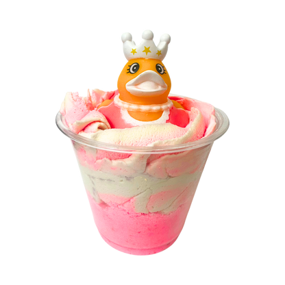Bubble bomb with a duck toy wearing a crown on a white background
