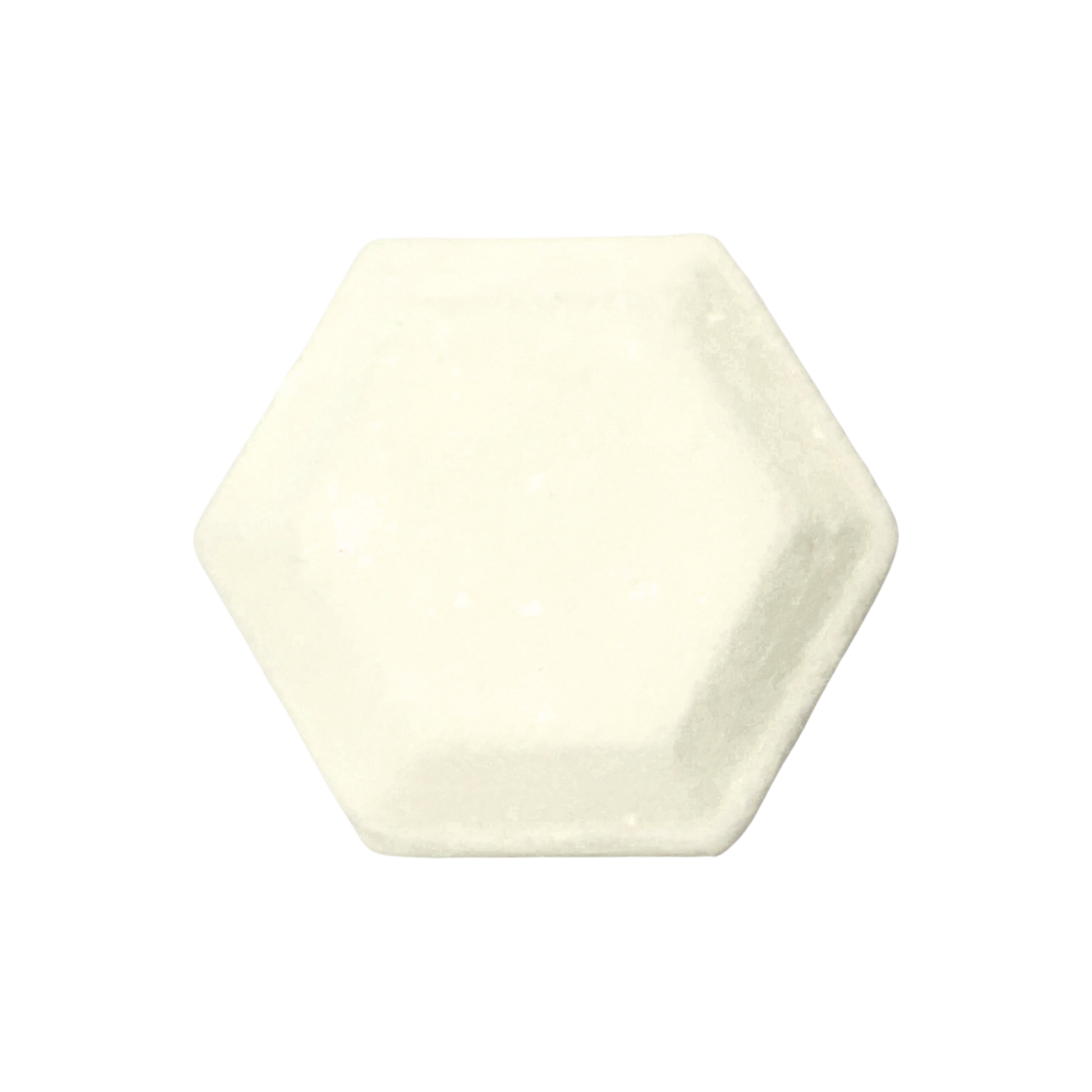 Hexagonal shower steamer in a plain cream color on a white background