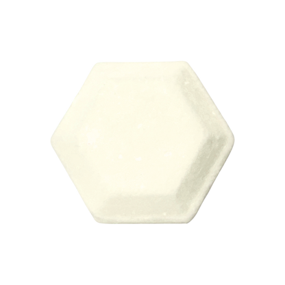 Hexagonal shower steamer in a plain cream color on a white background