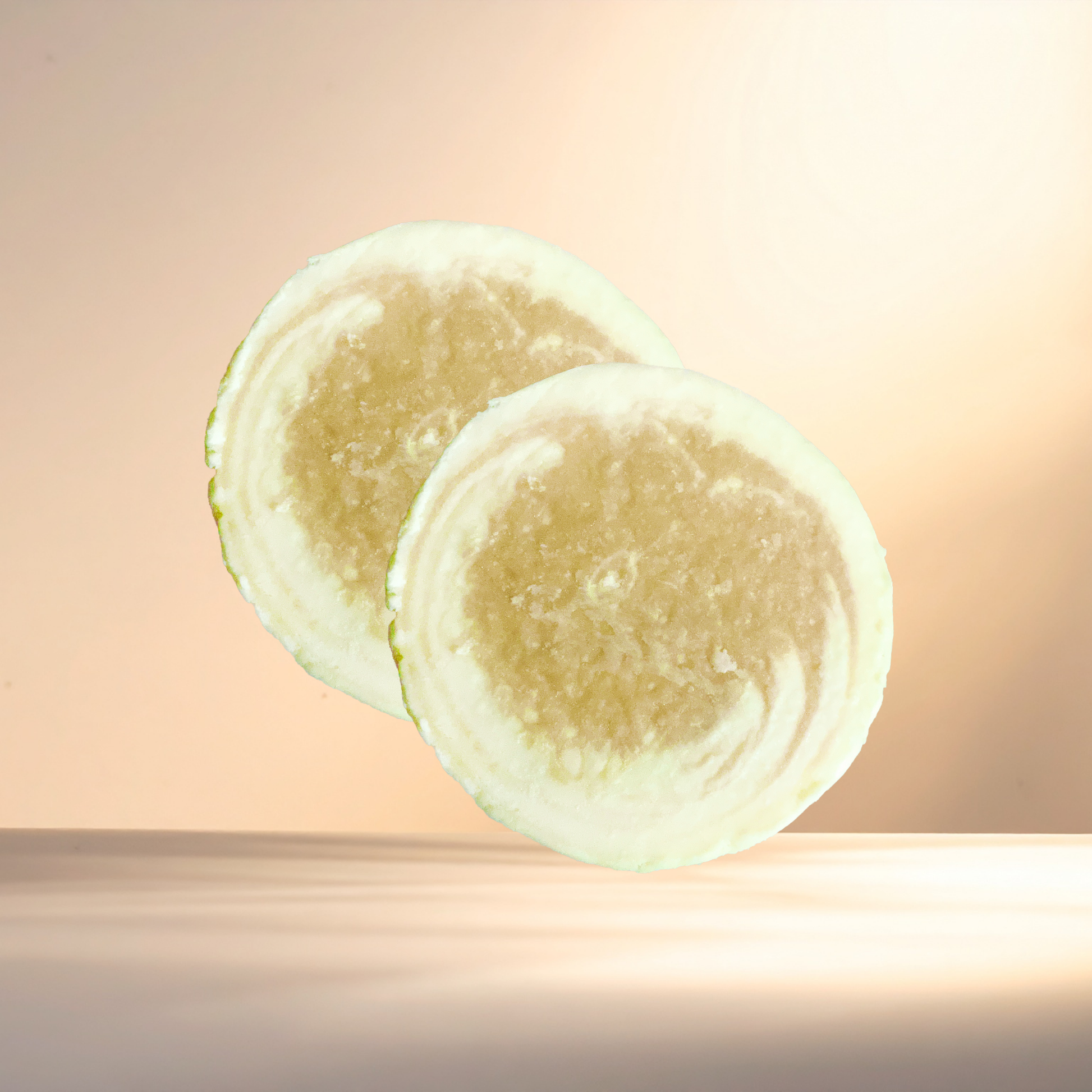 Two bars of soap on a gradient background