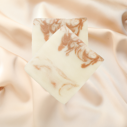Marble-patterned soap bar on a soft fabric background