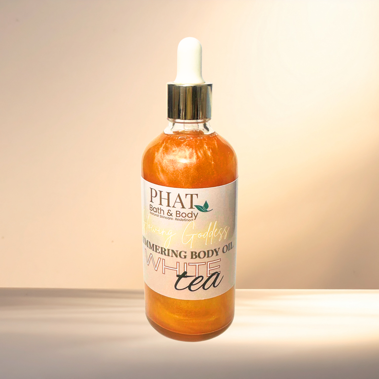 Bottle of PHAT Bath & Body White Tea body oil on a neutral background
