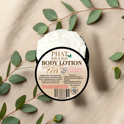 Body lotion container with 'Phat Bath & Body' label on a beige fabric background with green leaves.