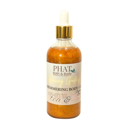 Bottle of PHAT Bath & Body shimmering body oil with a gold cap on a white background
