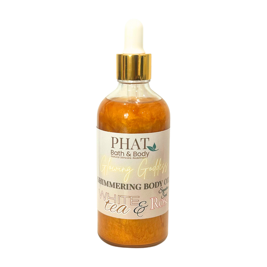 Bottle of PHAT Bath & Body shimmering body oil with a gold cap on a white background