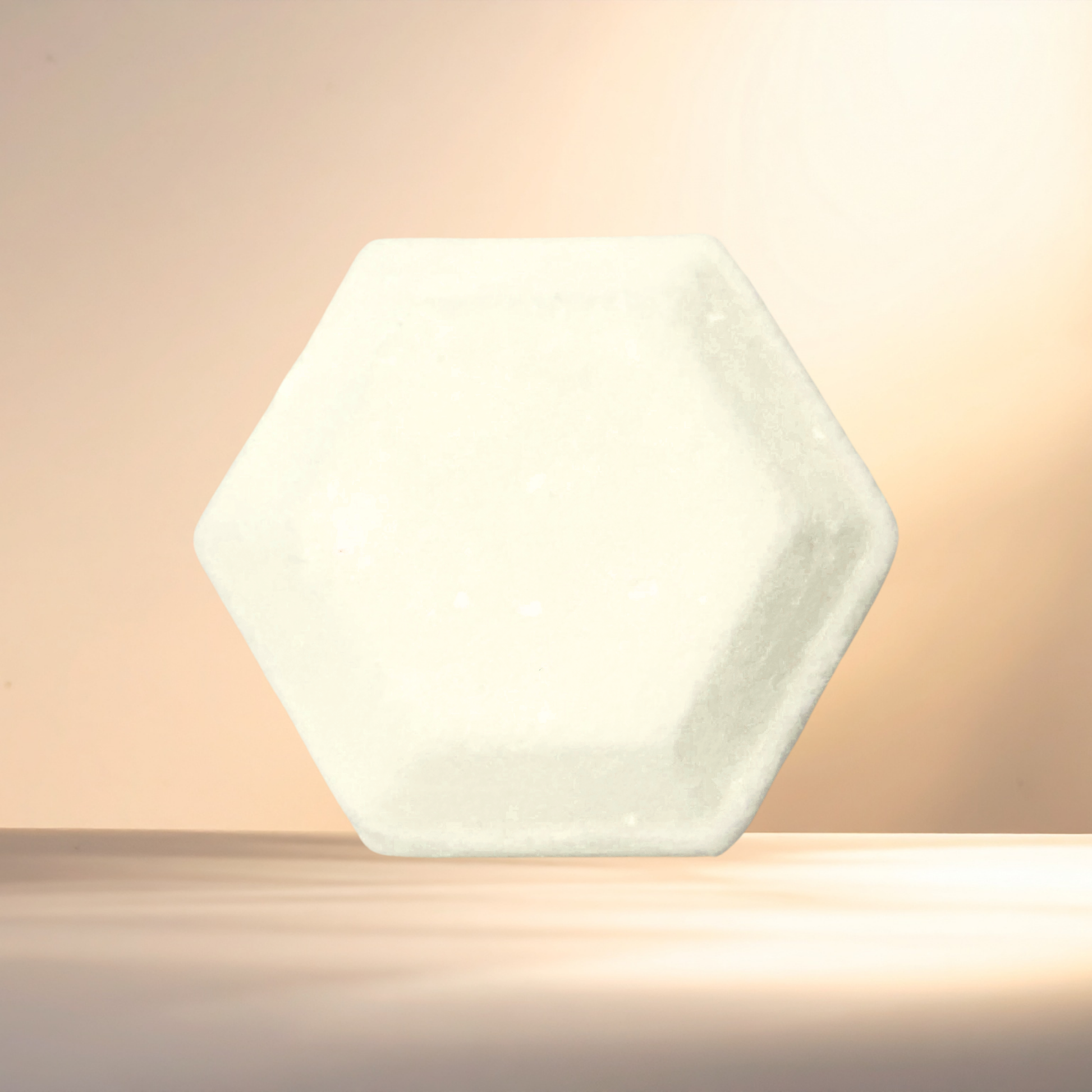 Hexagonal white steamer on a beige background