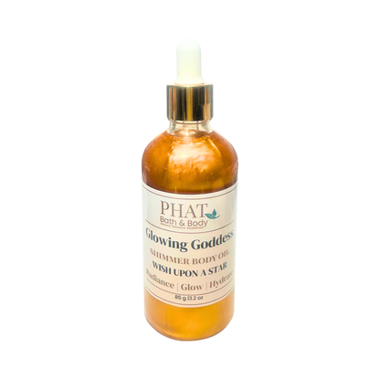 Orange bottle of 'Glowing Goddess' shimmer body oil by Phat Bath & Body on a white background