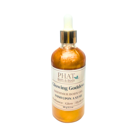 Orange bottle of 'Glowing Goddess' shimmer body oil by Phat Bath & Body on a white background