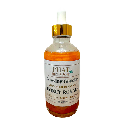Phat Bath & Body Honey Royale shimmering body oil in a glass bottle with a gold cap for radiant hydrated skin